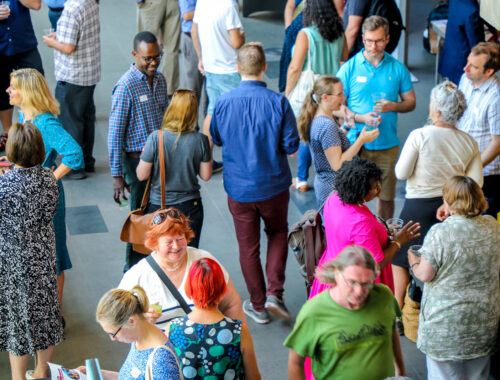 Educators and researchers mingle at a conference.