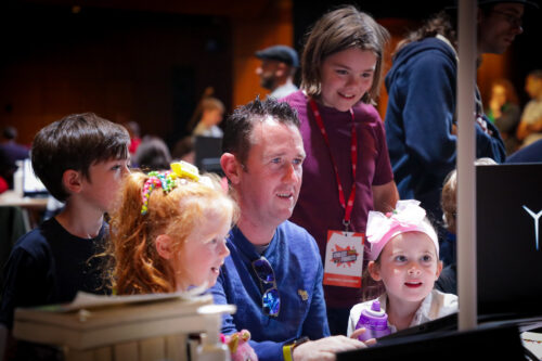 Young people and an adult mentor at a computer at Coolest Projects Ireland 2023.