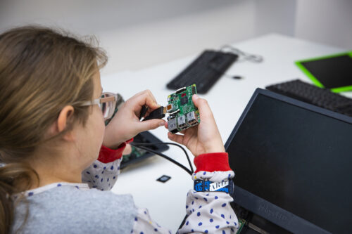 A girl with a Raspberry Pi computer.