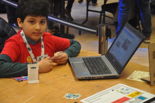 A young tech creator with a laptop at Coolest Projects Belgium.