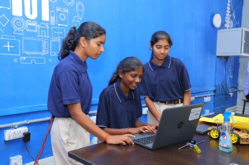 Three female students at the Coding Academy in Telangana.