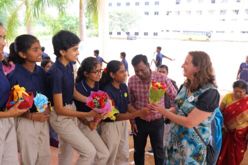 Students welcome Rachel Bennett at the Coding Academy in Telangana.