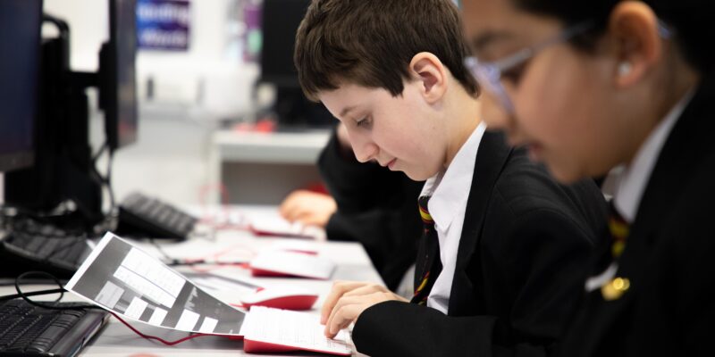 Secondary school age learners in a computing classroom.