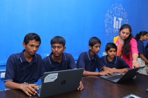 A group of students and a teacher at the Coding Academy in Telangana.