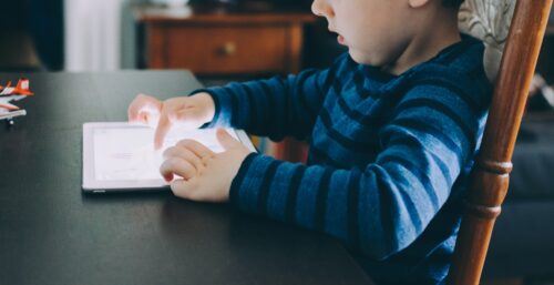 Child with tablet.