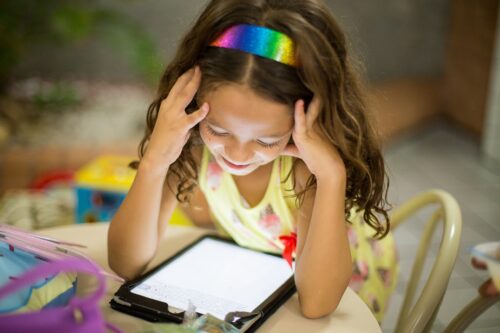 Child with tablet.