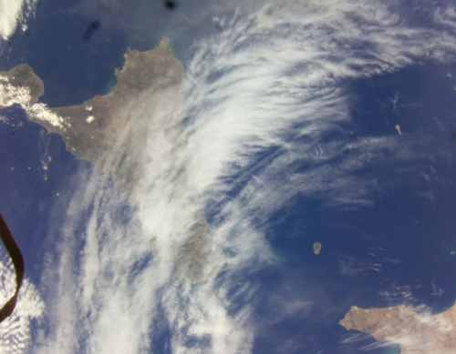 A photo the Mediterranean sea with the coastline of Sicily and Tunisia