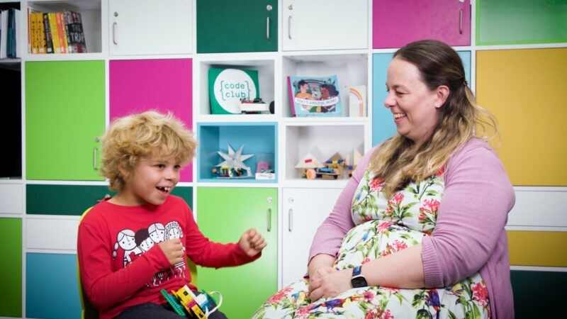 A parent and child laughing together.