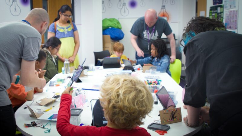 Young people and adult mentors at a Code Club session.