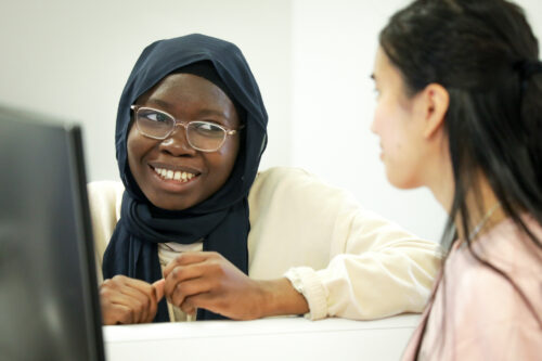 Two teenage learners in a classroom.