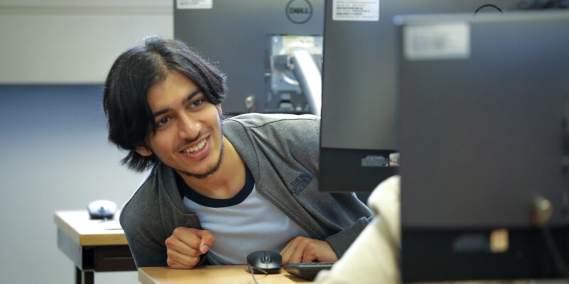 A student in a computing classroom.