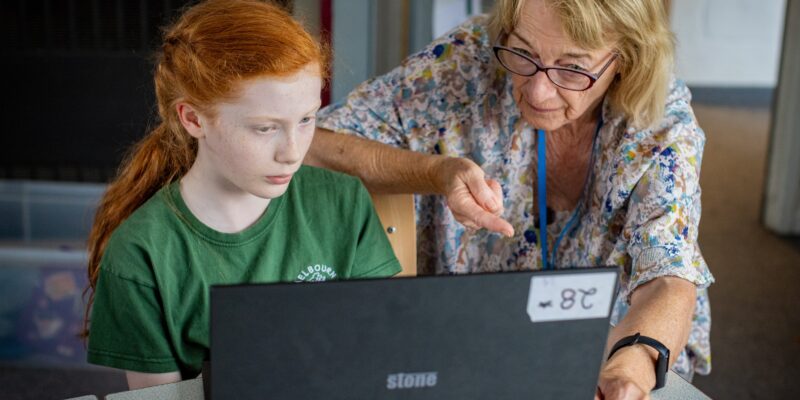 A learner and educator at a laptop.