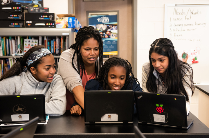 Young people with a teacher in the classroom