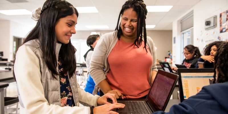 An educator helps a learner in the classroom