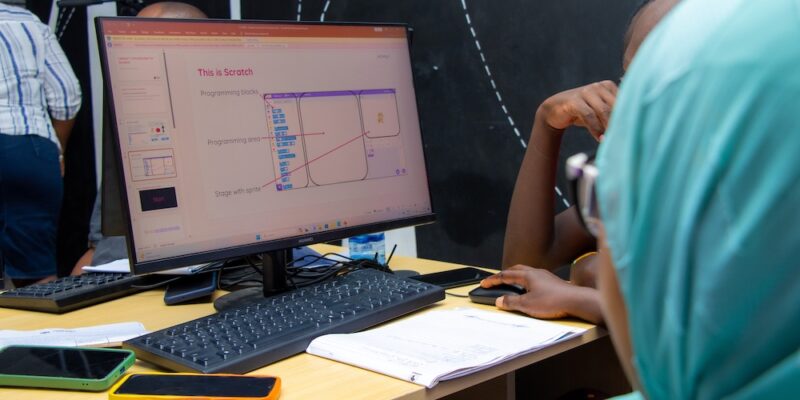 Students code in Scratch on a computer.