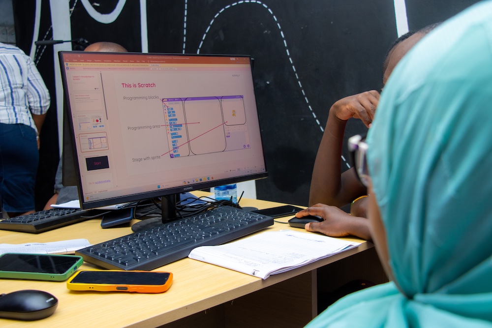Students code in Scratch on a computer.