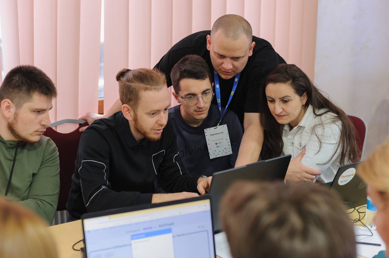 A group of educators looking at a laptop screen.