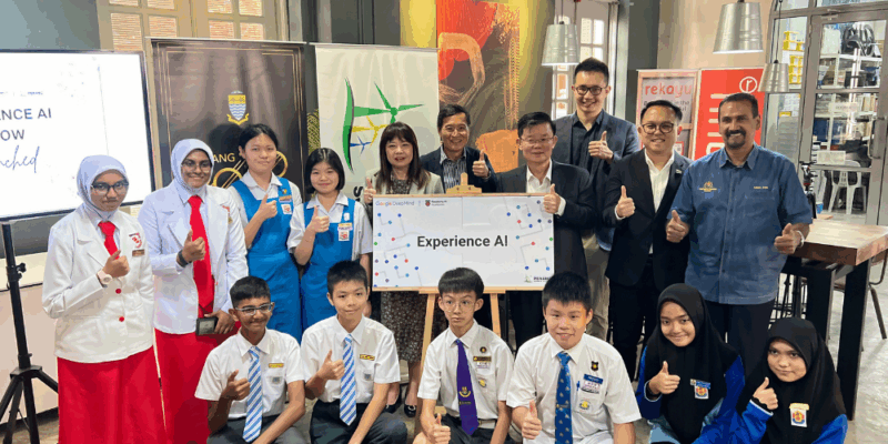 A group of students and educators holding an Experience AI poster.