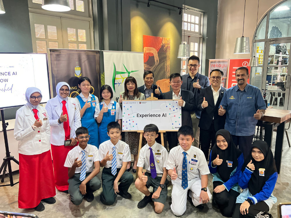 A group of students and educators holding an Experience AI poster.