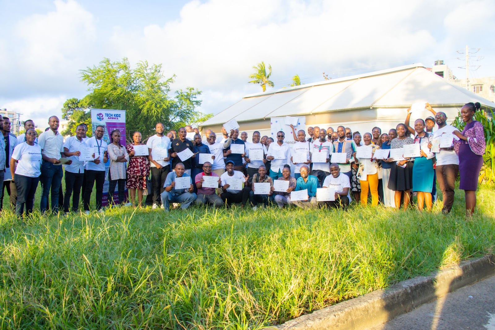 A group of students holding the Experience AI certificates.