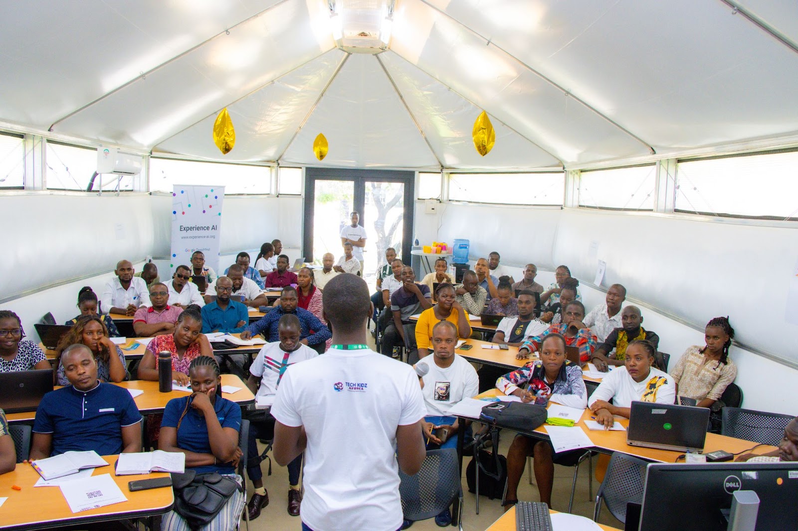 An educator with students at the Experience AI workshop.
