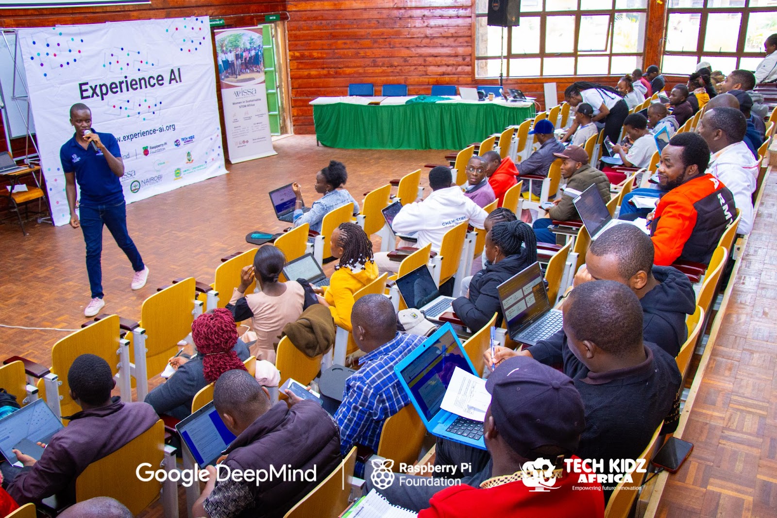 An educator with students at the Experience AI workshop.