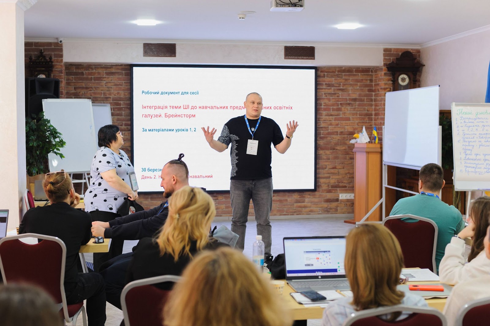 A man is delivering a presentation about Experience AI to a group of educators.