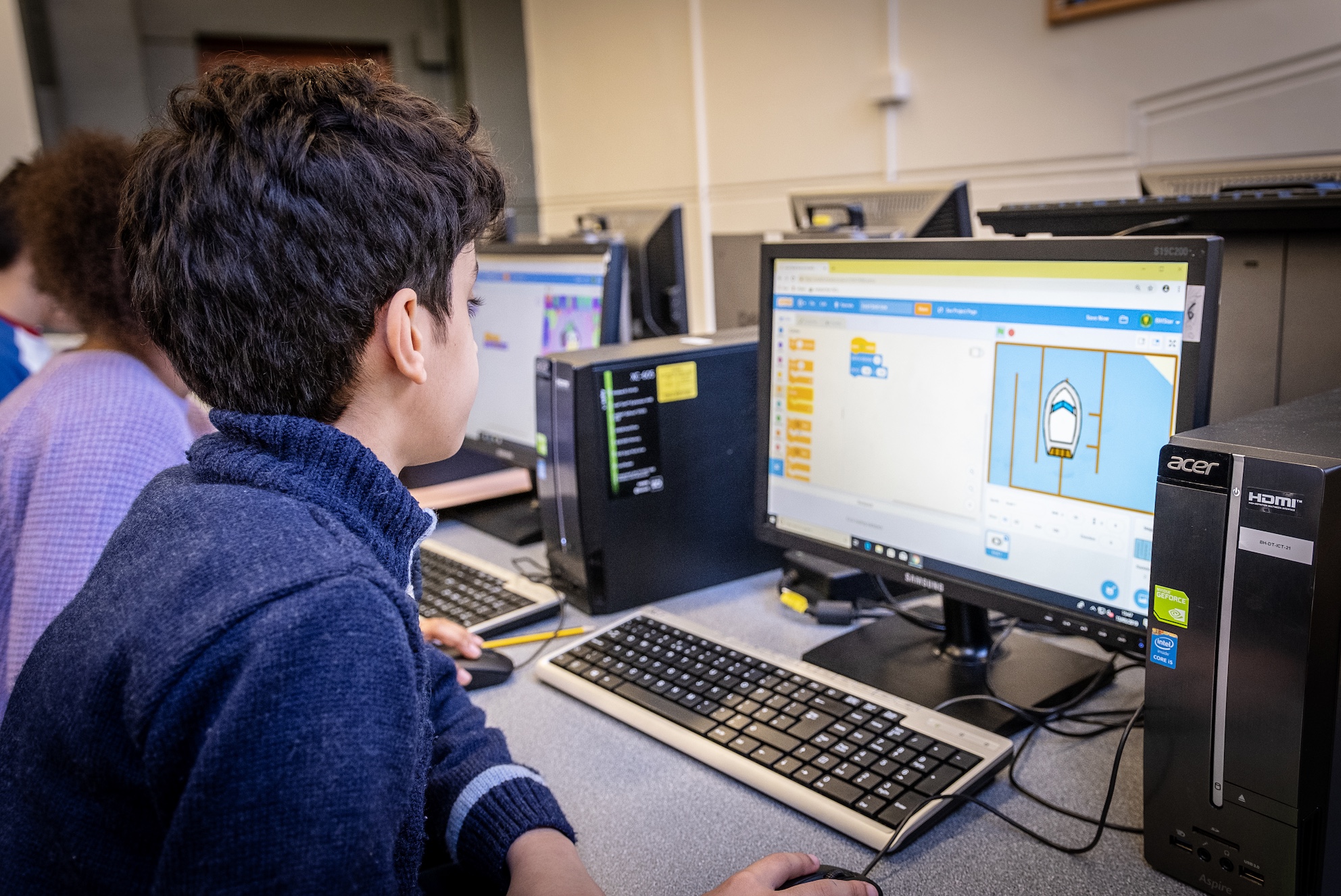 Young child in the classroom using Scratch to program.