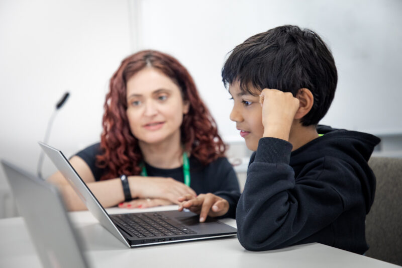 A young person and mentor at a Code Club.