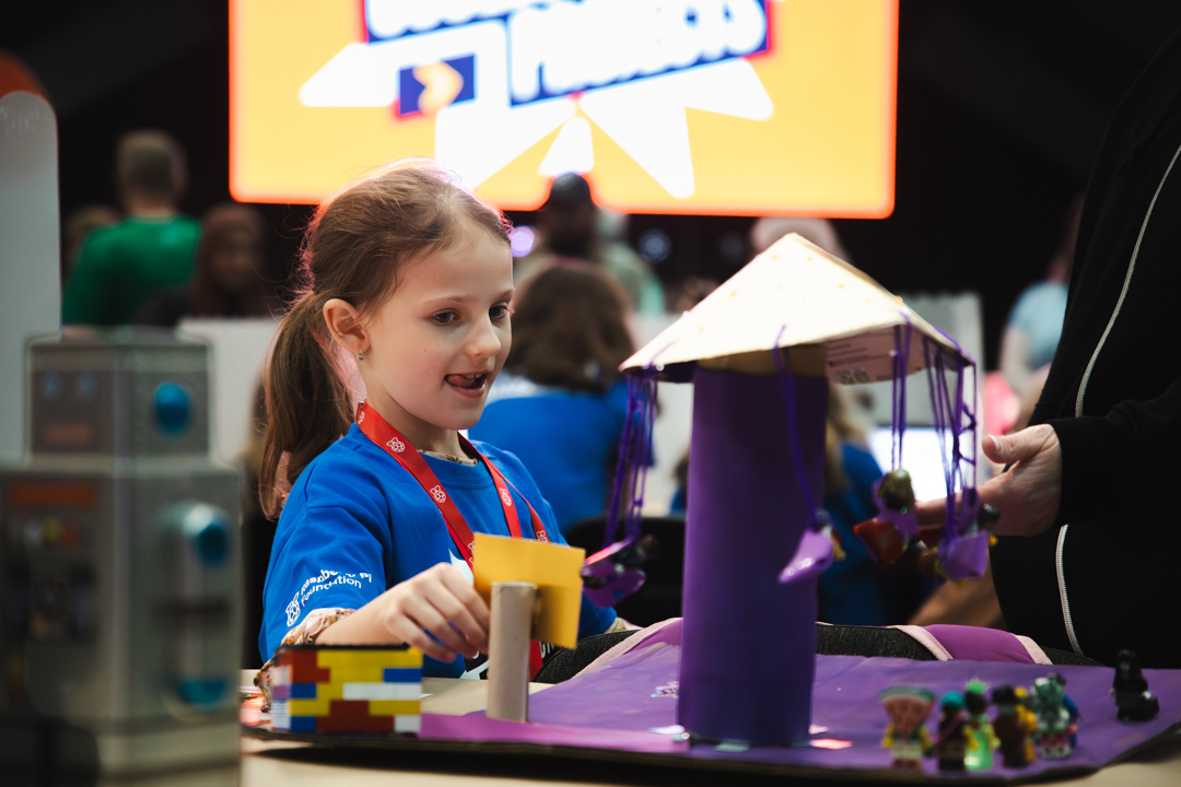 A young creator showcasing her hardware project.