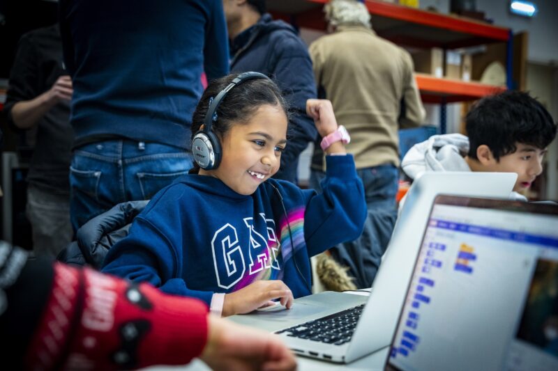 A young person celebrates at a Code Club.