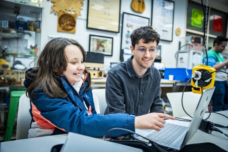 A young person and mentor at a Code Club.