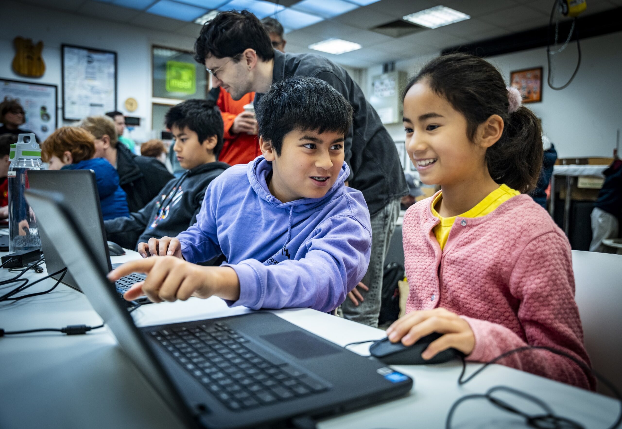 Two young people work together at a Code Club.