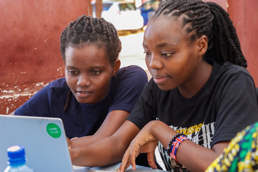 Two young people using a computer.