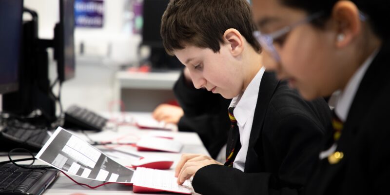 Photo of young people studying in a computing classroom.