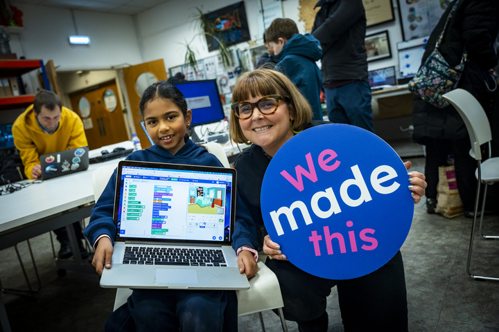 A mentor and a young person at a Code Club.