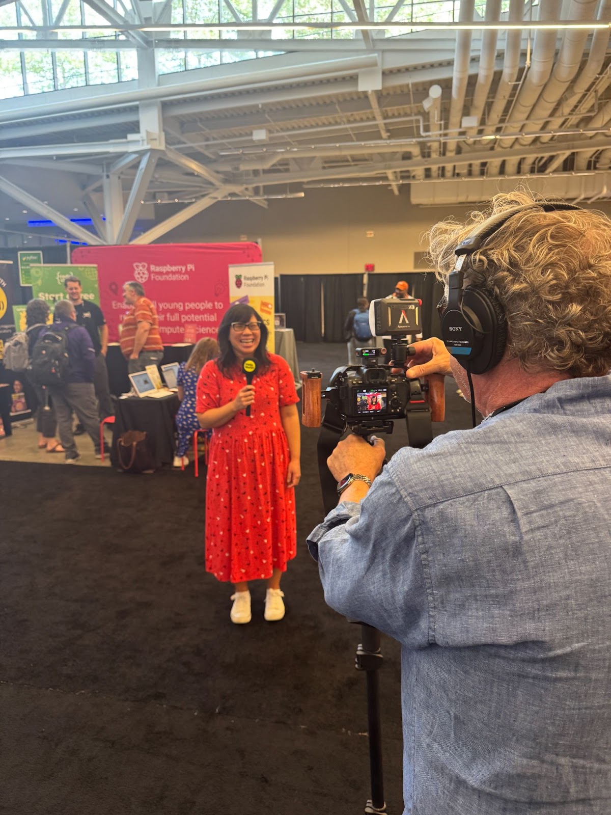 Behind the scenes of Meg Wang, editor of the Hello World magazine presenting the latest episodes of the Hello World podcast, from CSTA 2025.