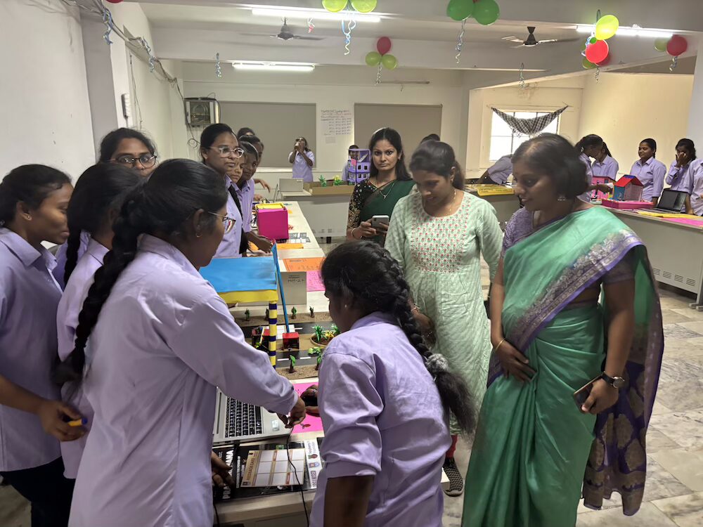 A group of female students working on a coding project.