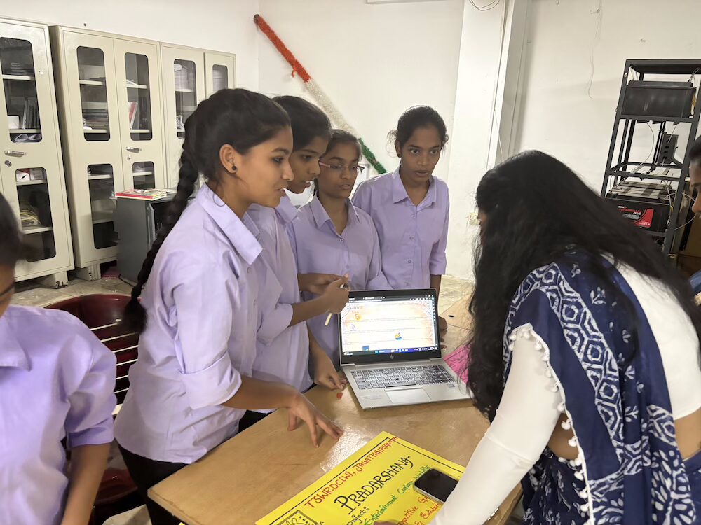 A group of female students working on a coding project.