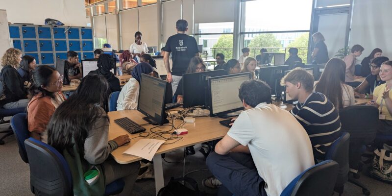 Photo of a class of students at computers, in a computer science classroom.