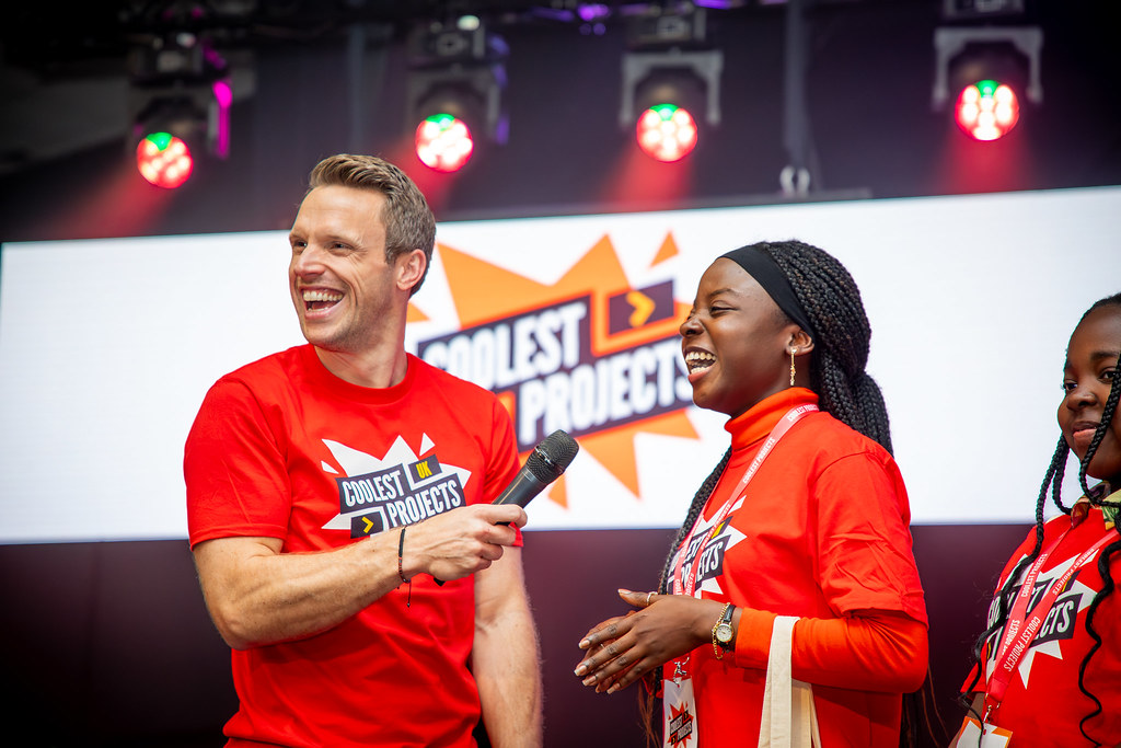 Inilouwa, 18, speaking with presenter on stage at Coolest Projects UK