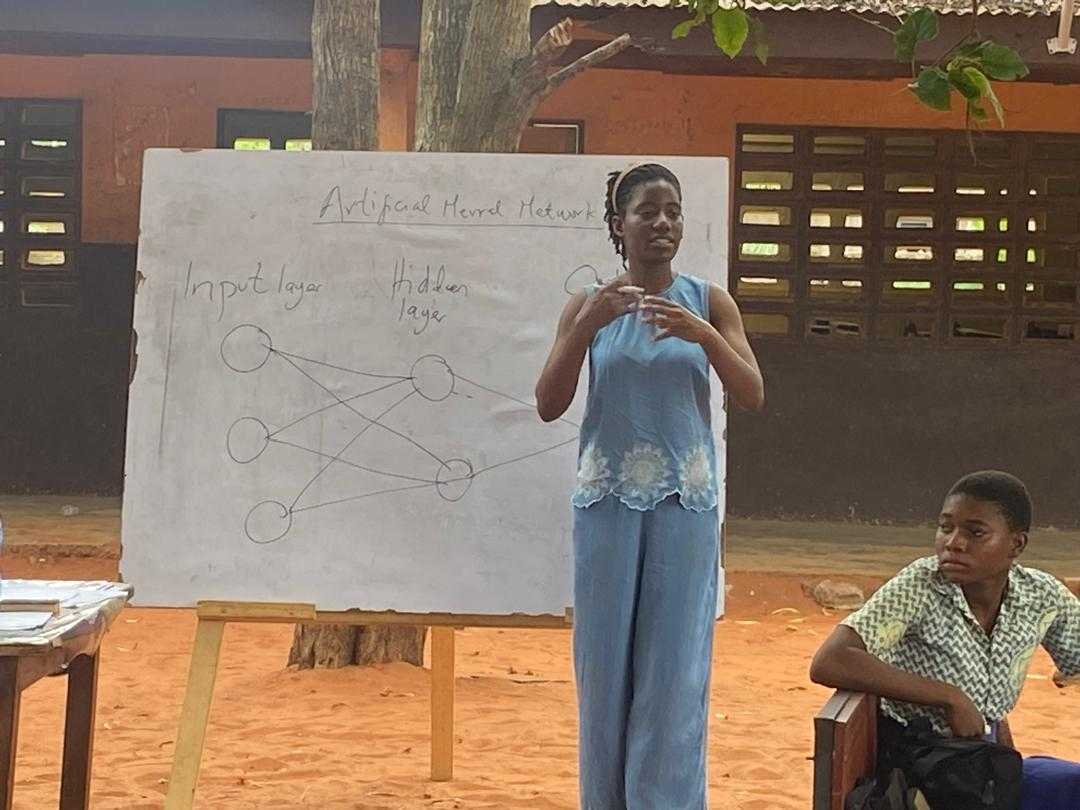 PhD student Salomey explaining how the unplugged resources worked in a teacher PD session in Ghana