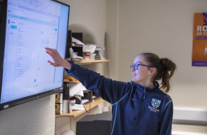 A young learner showing a Python project in the Code Editor.
