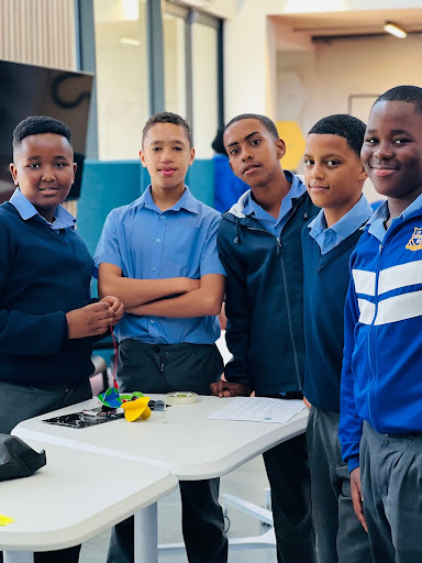 A group of students standing around a table.