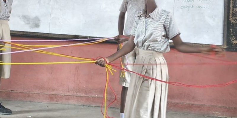 Students using rope to roleplay an artificial neural network.