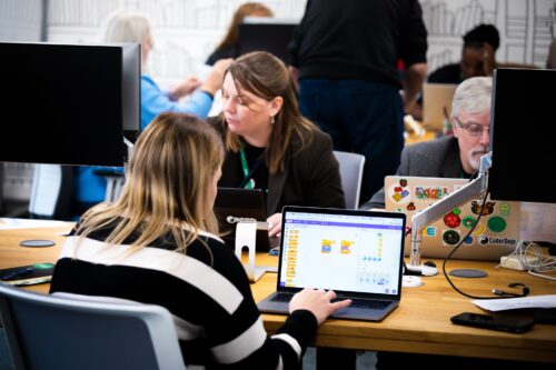 Photo of educators programming on Scratch in a computing classroom