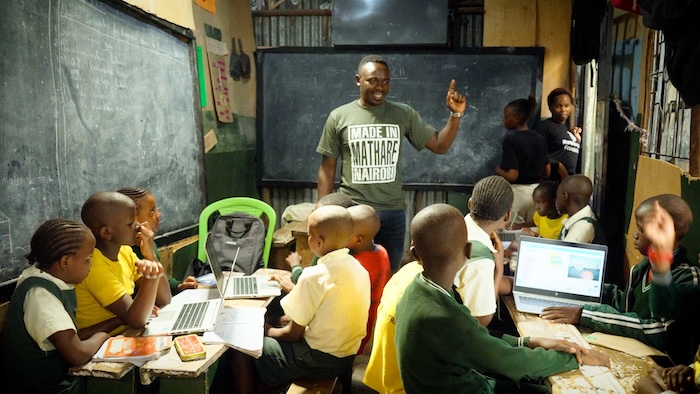 Douglas leading a Code Club session in a classroom.