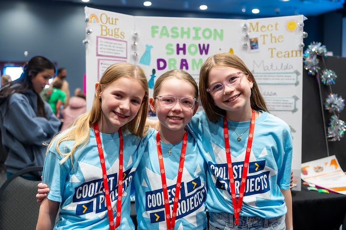 Three young tech creators at a Coolest Projects event