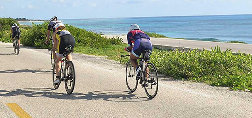 Cyclists on a road by the beach