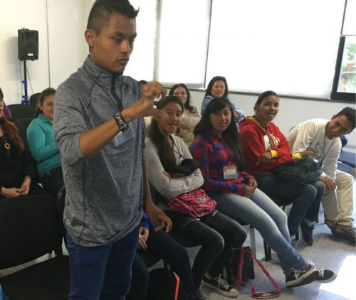 Jorge, a fifteen-year-old student taking part in the HolaMundo training, signs to the class
